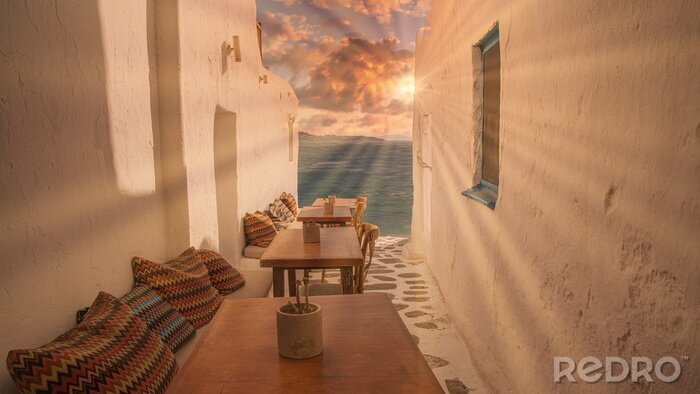Bild Benches with pillows in a typical Greek bar in Mykonos town with sea view, Cyclades islands, Greece. Travel concept.