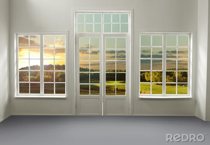 Bild Ein Blick auf eine Wiese bei Sonnenuntergang durch weiße Fenster