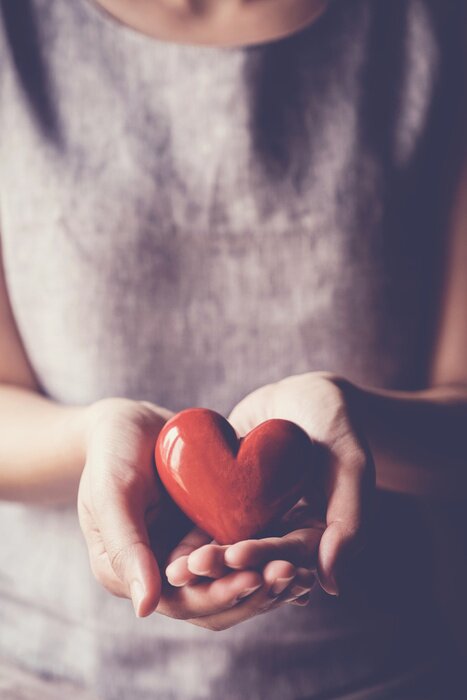 Bild hands and red heart, health insurance, donation and charity concept