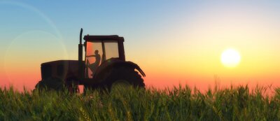Landwirt auf einem Traktor bei Sonnenaufgang