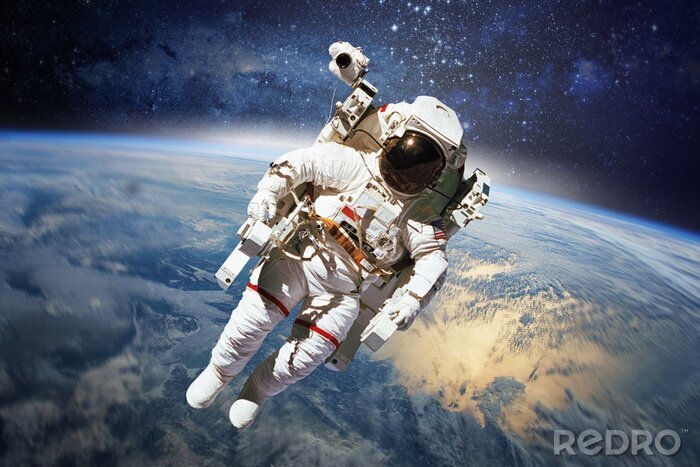 Fototapete Astronaut im Weltraum vor dem Erde-Hintergrund