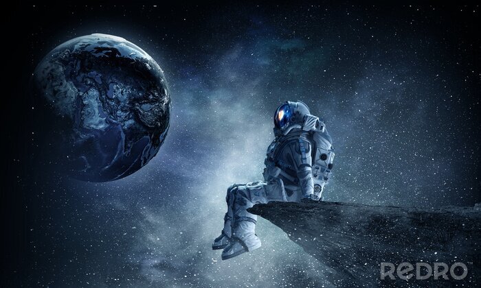 Fototapete Astronaut schaut auf einen geheimnisvollen Planeten