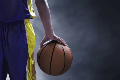 Fototapete Basketball Ball in der Hand eines Spielers