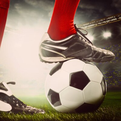 Fototapete Beine des Fußballspielers am Ball