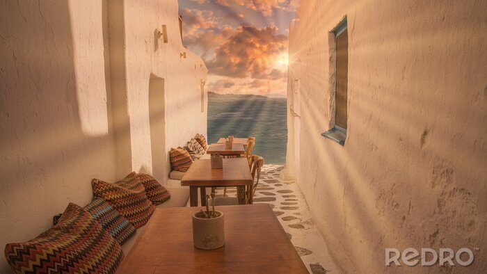 Fototapete Benches with pillows in a typical Greek bar in Mykonos town with sea view, Cyclades islands, Greece. Travel concept.