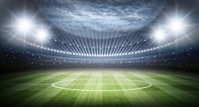 Fototapete Blick auf das Spielfeld und das von Flutlicht beleuchtete Stadion
