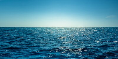 Fototapete Blue ocean panorama with sun reflection, The vast open sea with clear sky, Ripple wave and calm sea with beautiful sunlight