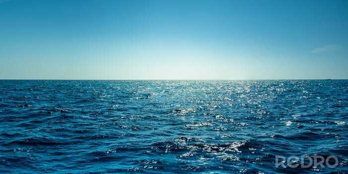 Fototapete Blue ocean panorama with sun reflection, The vast open sea with clear sky, Ripple wave and calm sea with beautiful sunlight