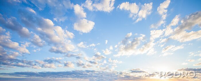 Fototapete Blue sky clouds background. Beautiful landscape with clouds and orange sun on sky