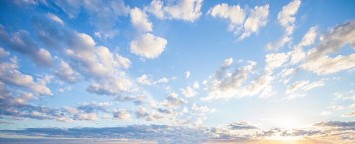 Fototapete Blue sky clouds background. Beautiful landscape with clouds and orange sun on sky