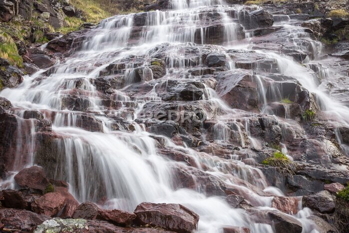 Fototapete Close up details of scenic, colorful, powerful Monk's jump waterfall on Old mountain, the tallest in Serbia, streaming down the red, rocky cliff