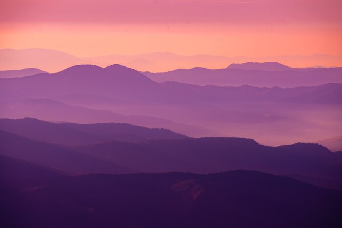 Fototapete Die untergehende Sonne malt Farben in den Himmel