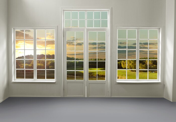 Fototapete Ein Blick auf eine Wiese bei Sonnenuntergang durch weiße Fenster