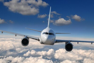 Fototapete Ein Flugzeug über den Wolken