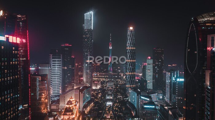 Fototapete Ein Stadtpanorama mit beleuchteten Wolkenkratzern