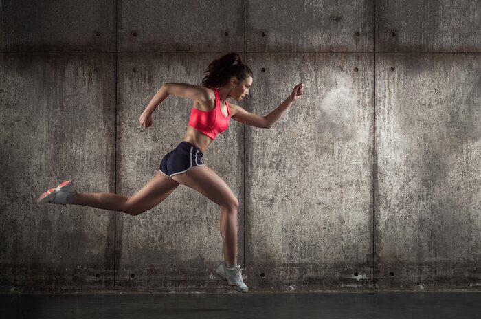 Fototapete Eine laufende Frau in Sportkleidung im Profil