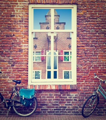 Fototapete Fahrräder vor fenster in amsterdam