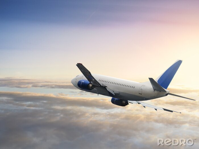 Fototapete Großes Flugzeug über den Wolken