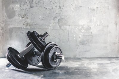 Fototapete Hanteln und Gewichte vor einem Betongegenstand