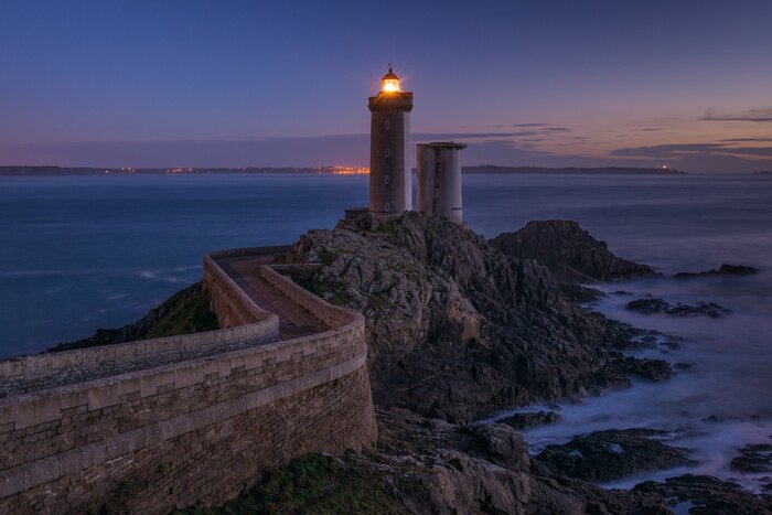 Fototapete In der Nacht leuchtender Leuchtturm