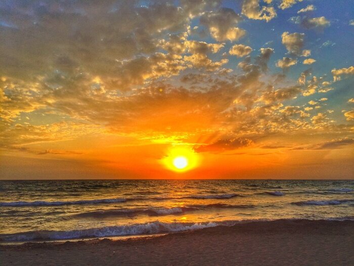 Fototapete Kleine Wellen am Meer bei Sonnenuntergang