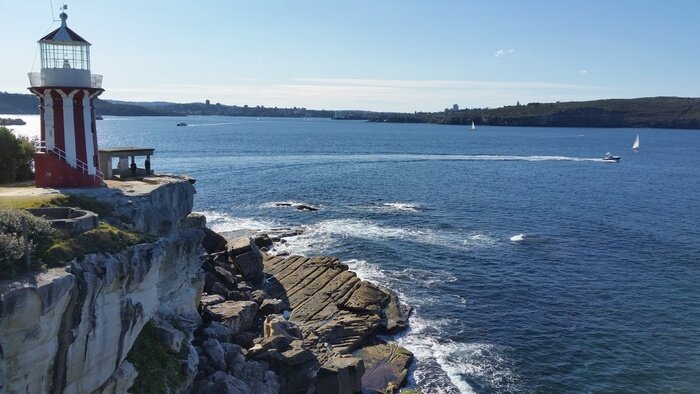Fototapete Leuchtturm an Bucht