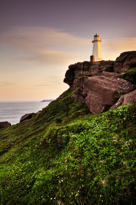 Fototapete Leuchtturm auf grünem Hügel