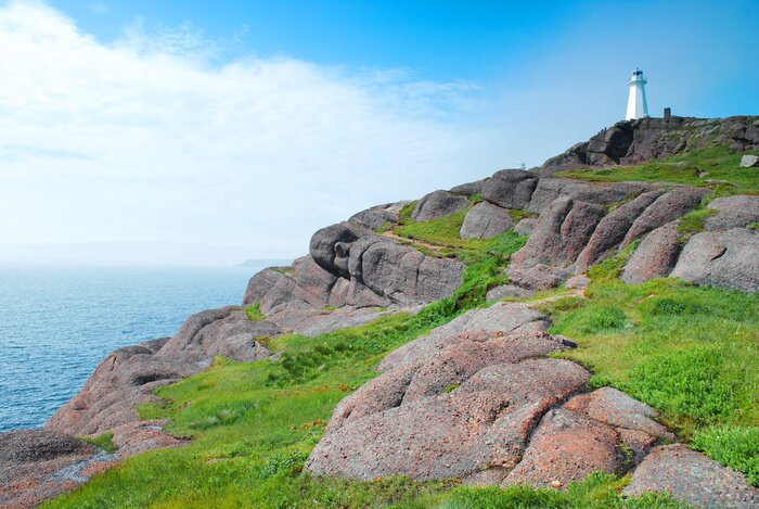 Fototapete Leuchtturm hoch auf Felsen