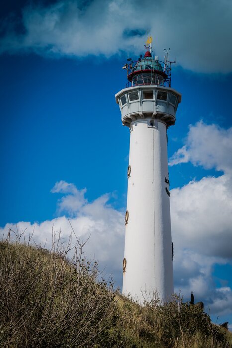 Fototapete Leuchtturm mit Wolken im Hintergrund