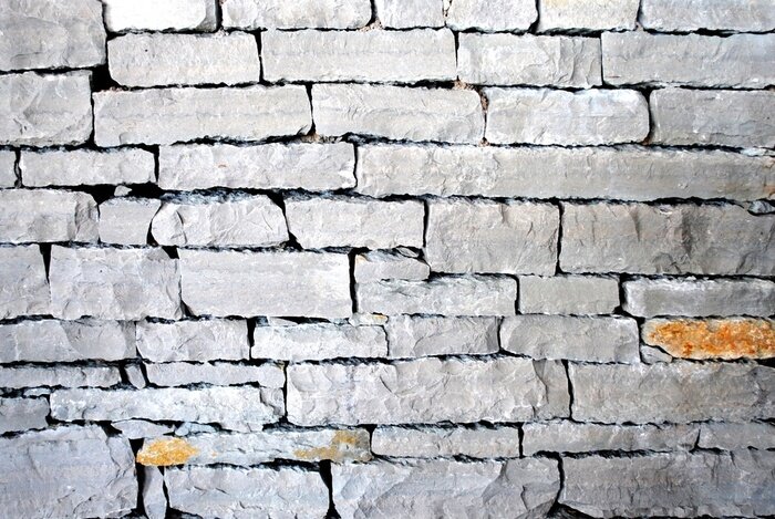 Fototapete Mauer aus grau-orangenfarbenen Schiefern