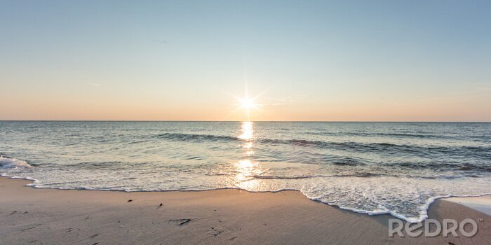 Fototapete Meer und Strand im Schein der untergehenden Sonne