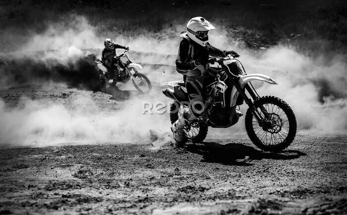 Fototapete Motocross racer accelerating in dust track, Black and white photo