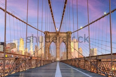 Fototapete New York, New York on the Brooklyn Bridge Promenade facing Manhattan's skyline at dawn.