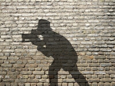 Fototapete Schatten vom Fotografen auf Mauer