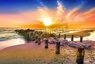 Fototapete Sonnenuntergang und Meereswellenbrecher