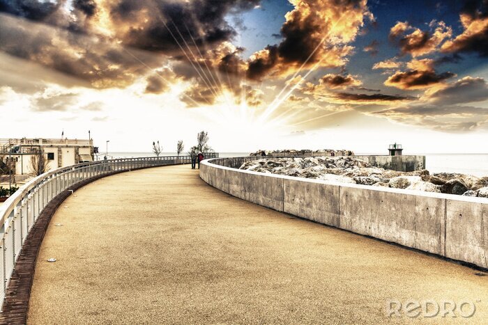 Fototapete Steinige Mole mit Leuchtturm