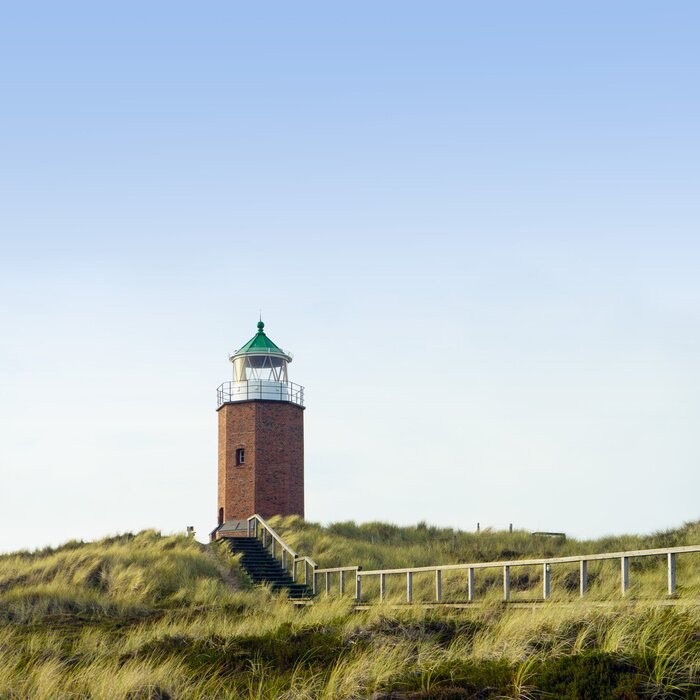 Fototapete Steiniger Leuchtturm auf Insel