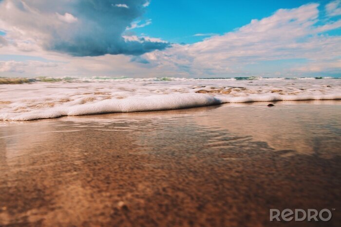 Fototapete Strand und geschäumte Welle