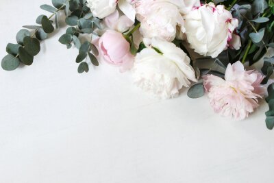 Fototapete Styled stock photo. Decorative still life floral composition. Wedding or birthday bouquet of pink and white peony flowers and eucalyptus branches. White table background. Flat lay, top view.