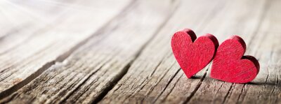 Two Wooden Hearts On Rustic Table With Sunlight
