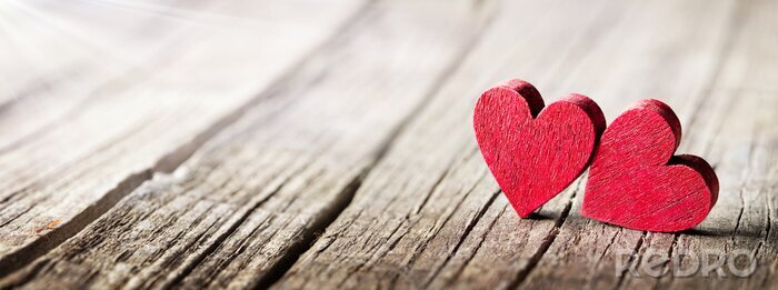 Fototapete Two Wooden Hearts On Rustic Table With Sunlight
