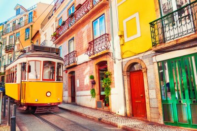 Fototapete Yellow vintage tram on the street in Lisbon, Portugal. Famous travel destination