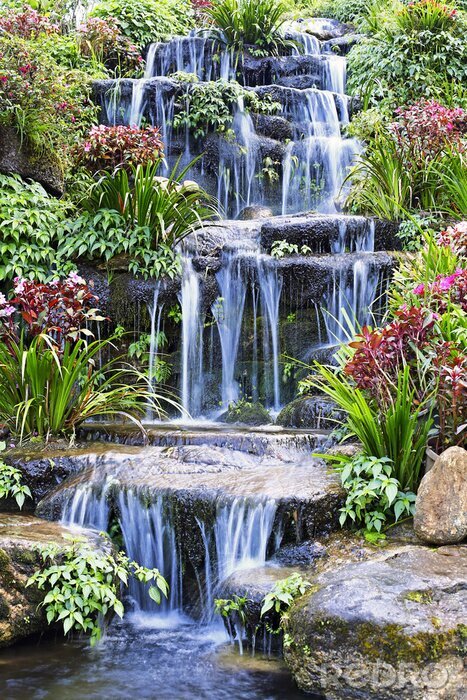 Poster Artificial waterfall and statue at the garden