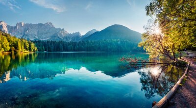 Colorful summer view of Fusine lake. Bright morning scene of Julian Alps with Mangart peak on background, Province of Udine, Italy, Europe. Traveling concept background.