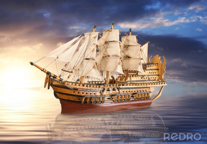 Poster Ein Segelboot vor dem Hintergrund eines goldenen Sonnenuntergangs