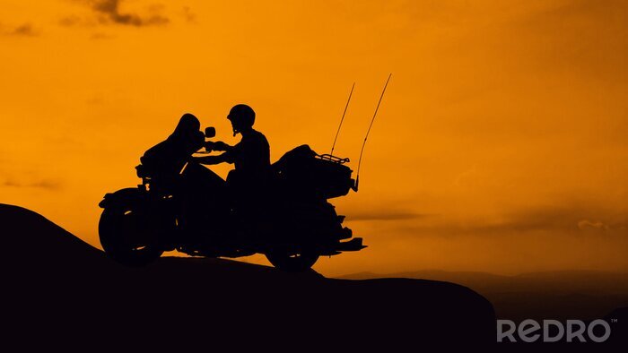 Poster Motorradfahrer und Sonnenuntergang Hintergrund