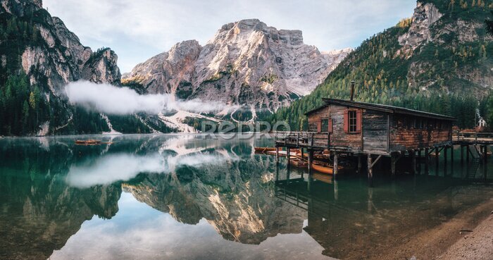 Poster Panoramablick von Braies Lake mit der Hütte und den Booten in den Dolomitbergen und in Seekofel morgens, Sudtirol, Italien