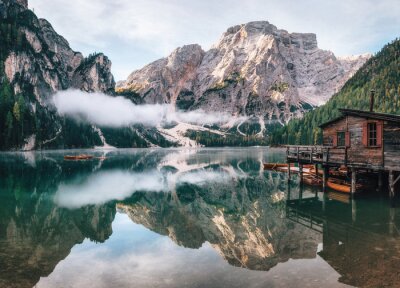 Panoramic view of Braies Lake with the hut and boats in Dolomites mountains and Seekofel in the morning, Pragser Wildsee, South Tirol, Italy
