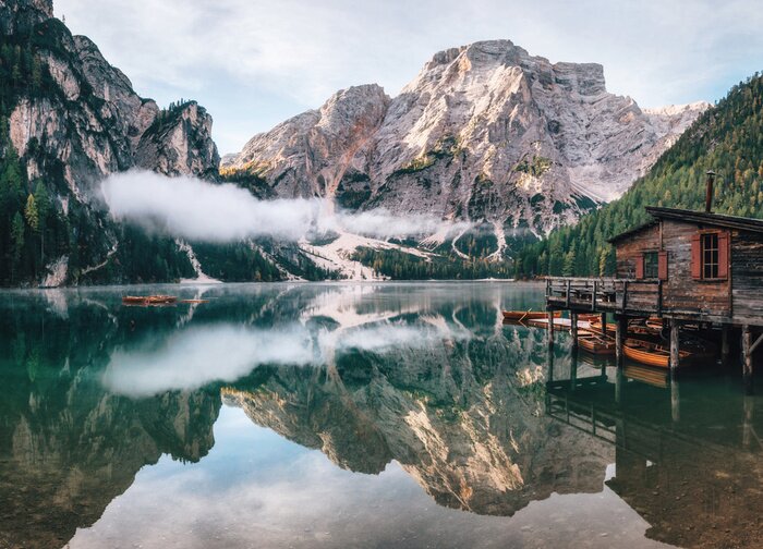 Poster Panoramic view of Braies Lake with the hut and boats in Dolomites mountains and Seekofel in the morning, Pragser Wildsee, South Tirol, Italy
