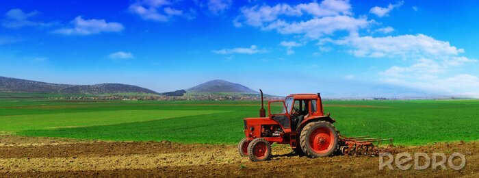 Poster Traktor in einer wunderschönen Landschaft